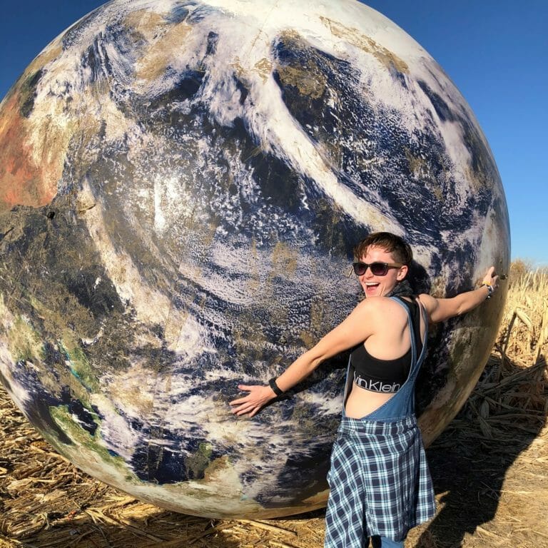 Taylor Reimann holding huge globe