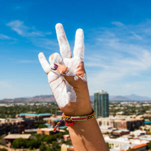 Hand of student painted in white making ASU forks hand gesture