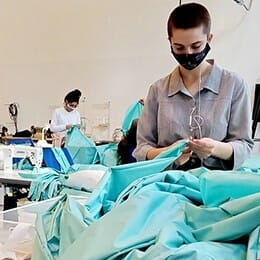 FABRIC personnel creating PPE gowns.