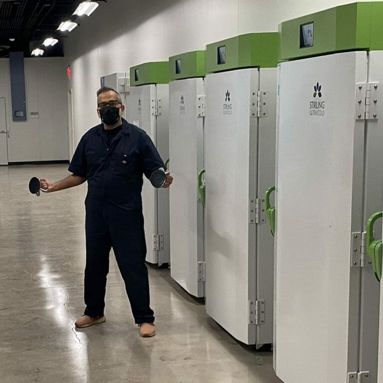Individual standing next to NEON's biorepository cabinets at ASU's Biodiversity Knowledge Integration Center