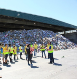 workers in green vests at recycling center