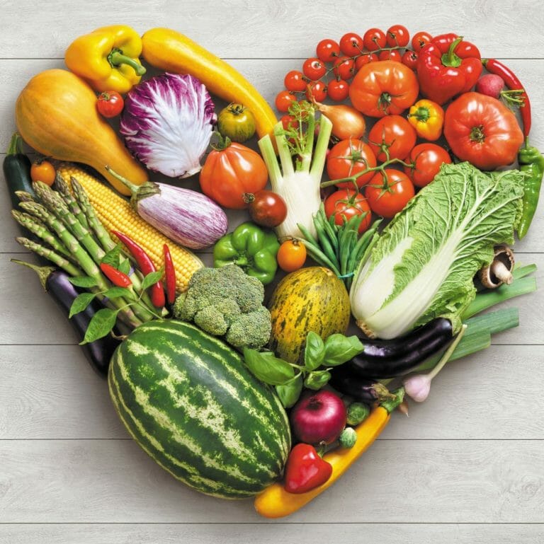 Heart symbol. Vegetables diet concept. Food photography of heart made from different vegetables on white wooden table. High reso