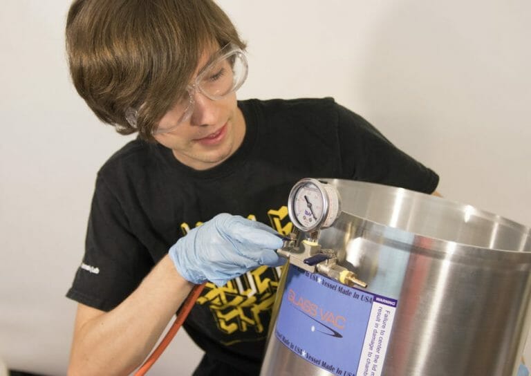ASU electrical engineering graduate student John Patterson plugs a tube into the sterilization unit on Tuesday, June 23, 2020.. vhp-student-2 Photo by ASU, The Luminosity Lab | Courtesy